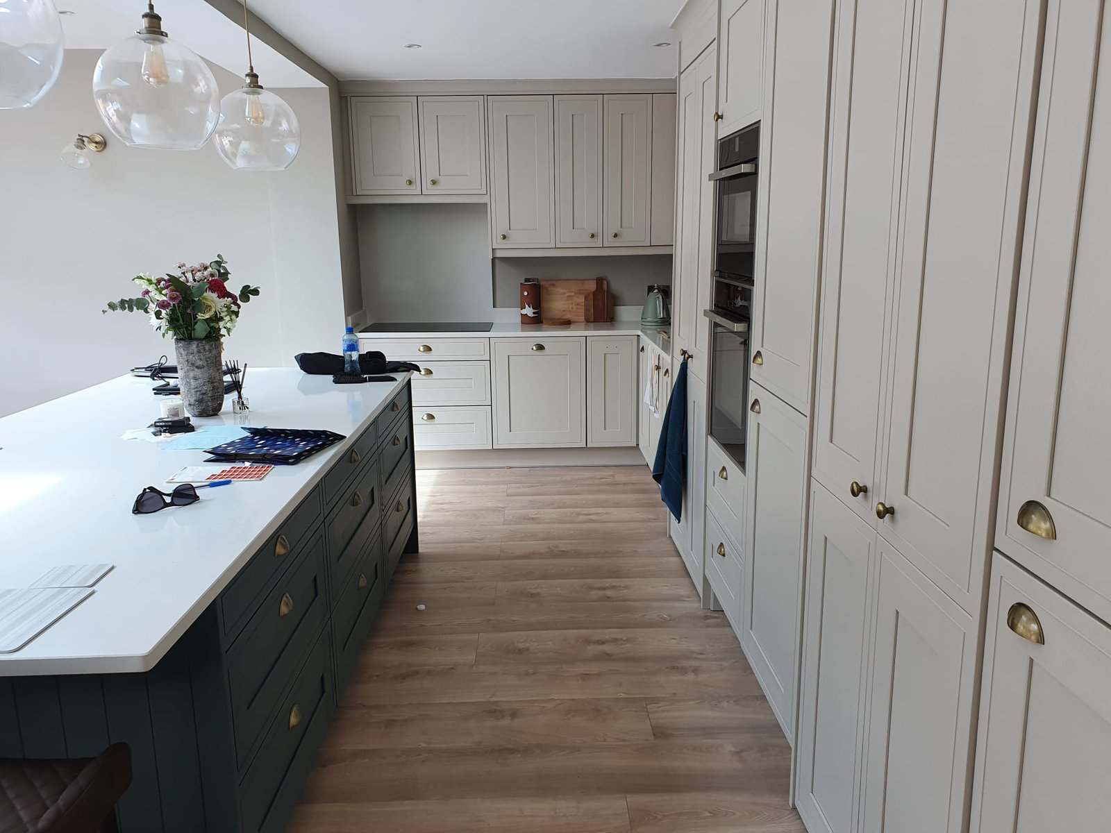 Modern kitchen with cream and dark green cabinetry