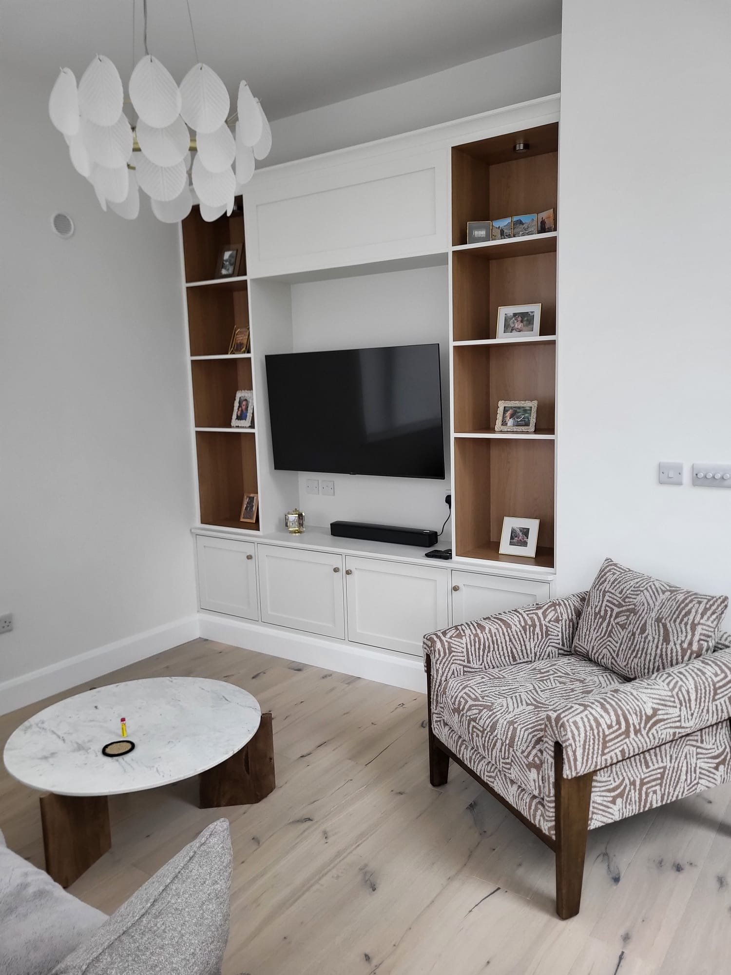 Living room with white and brown shelving unit