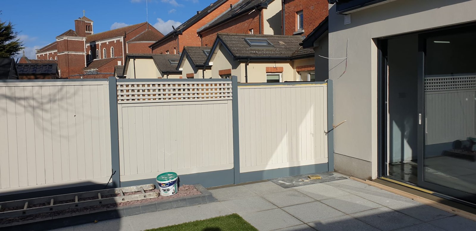 Modern patio with white fence and gate
