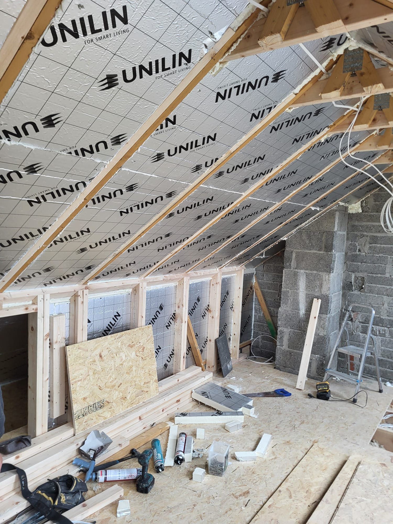Interior wall paneling and drywall installation in progress