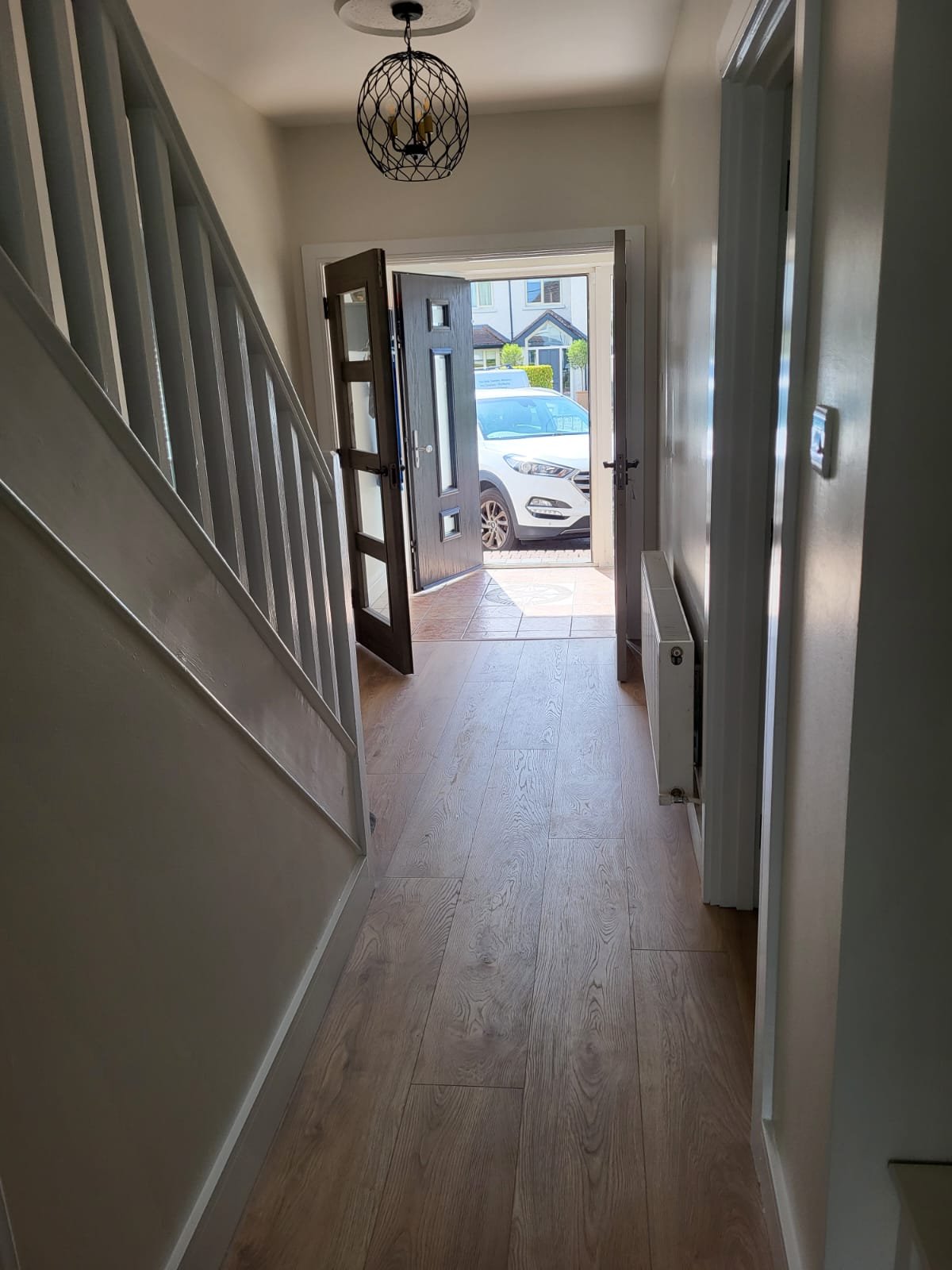 Modern hallway with wooden flooring and staircase