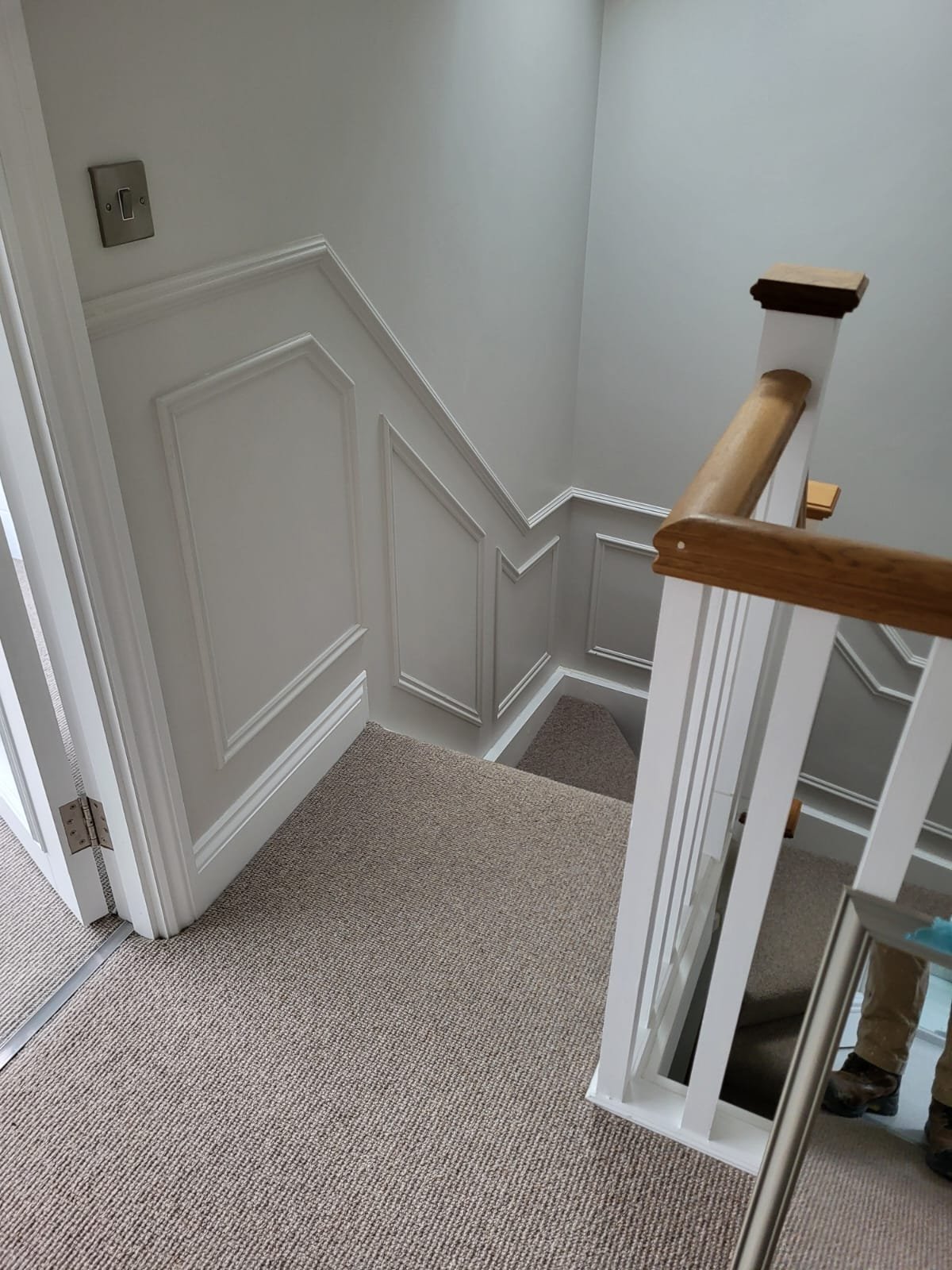 Modern staircase with white paneling