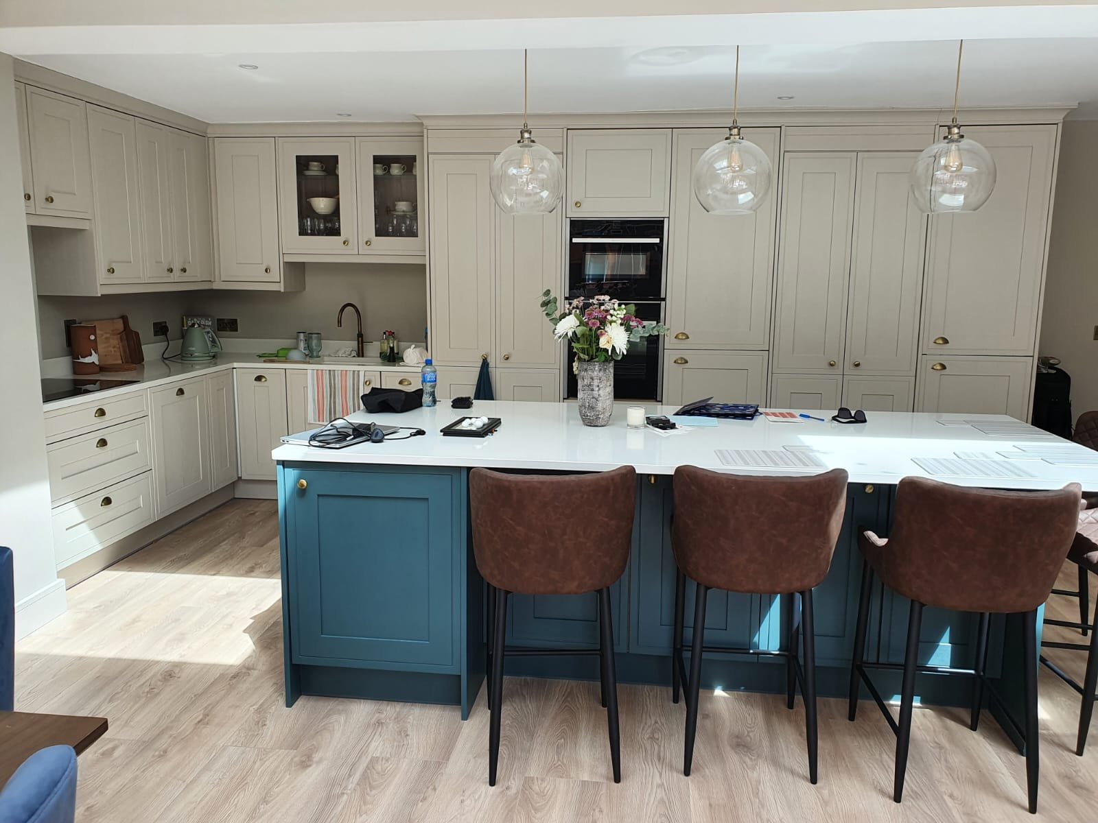 Kitchen with blue island and cream cabinetry