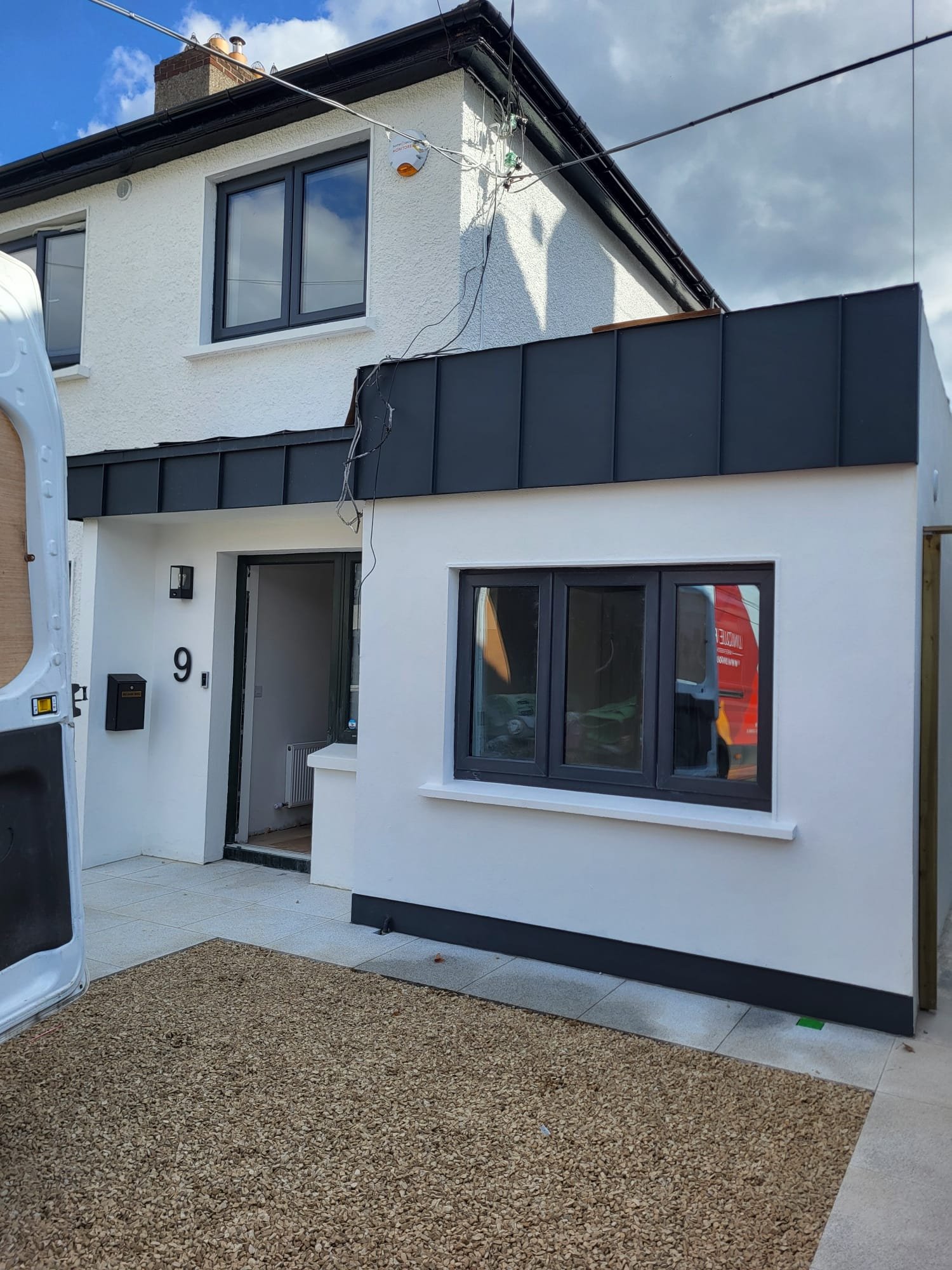 Modern white house with black bi-fold doors