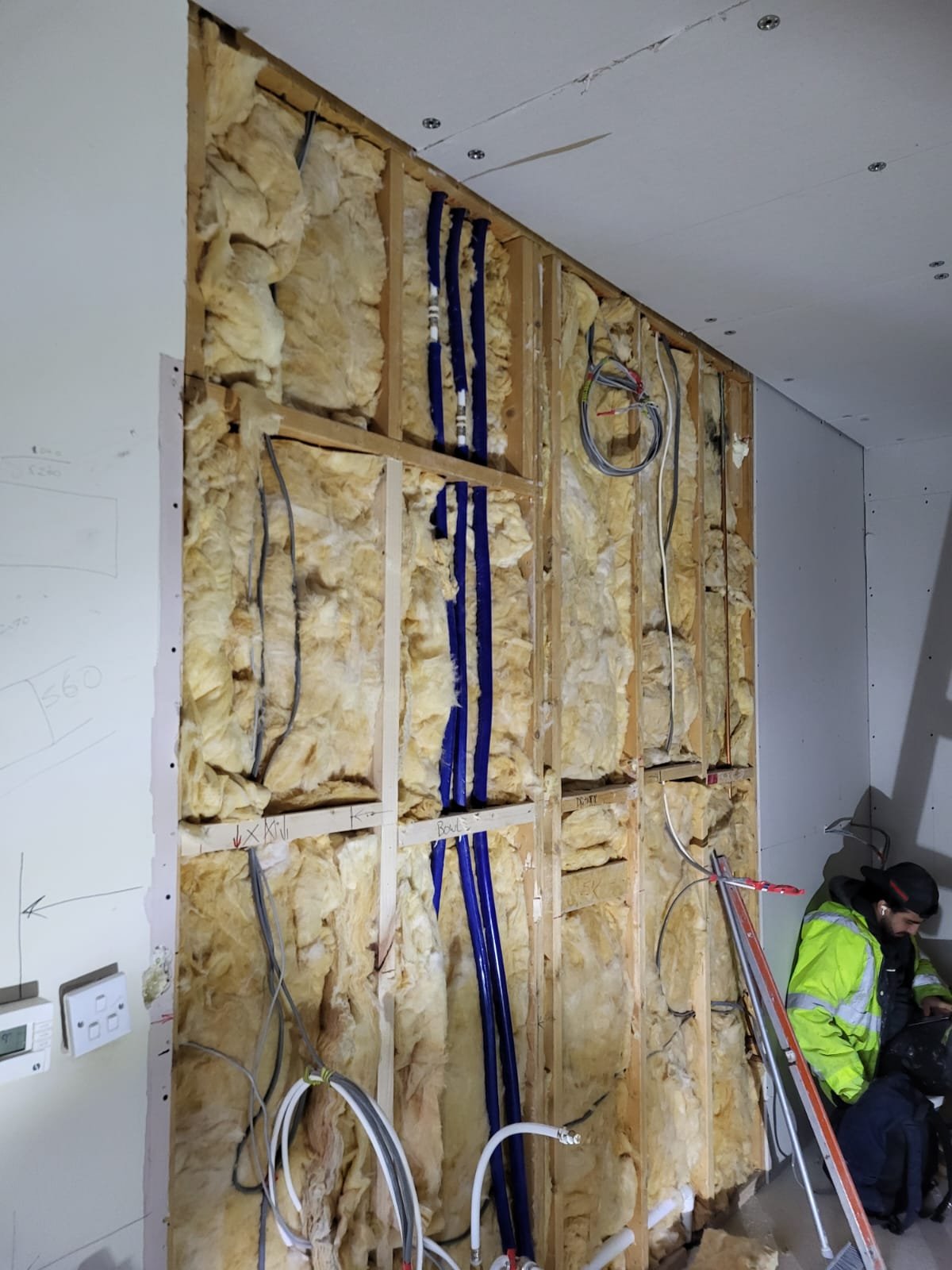 Wall insulation and electrical wiring installation in progress
