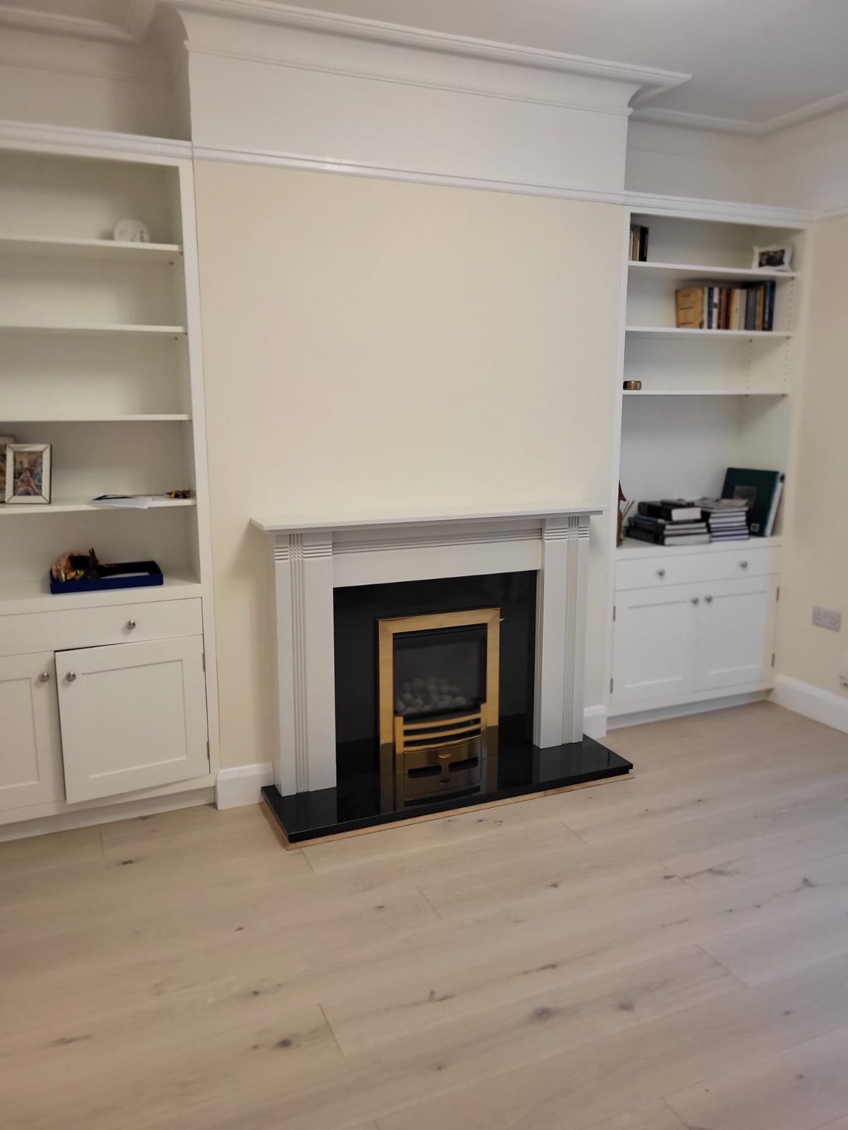 White built-in shelving with fireplace