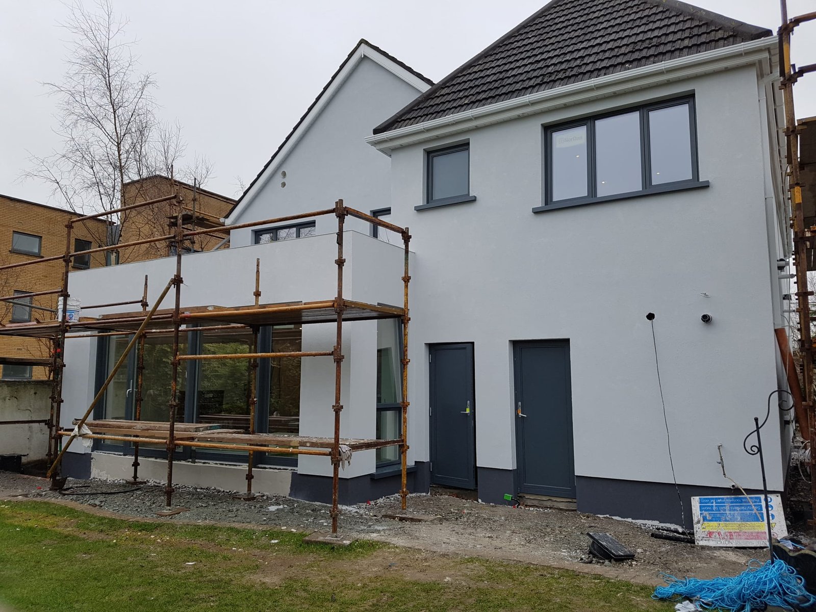 Luxury bathroom with dark floral wallpaper, green vanity, brass fixtures, and round mirror