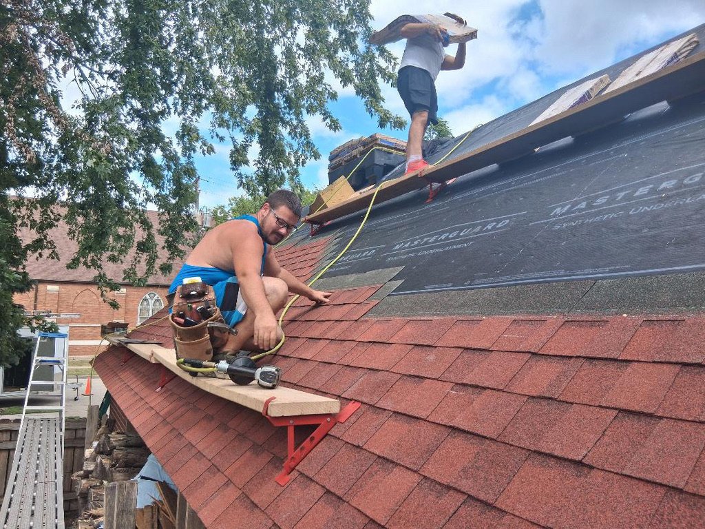 Streamline Framing roofing contractor installing charcoal-gray architectural shingles on a Wisconsin home