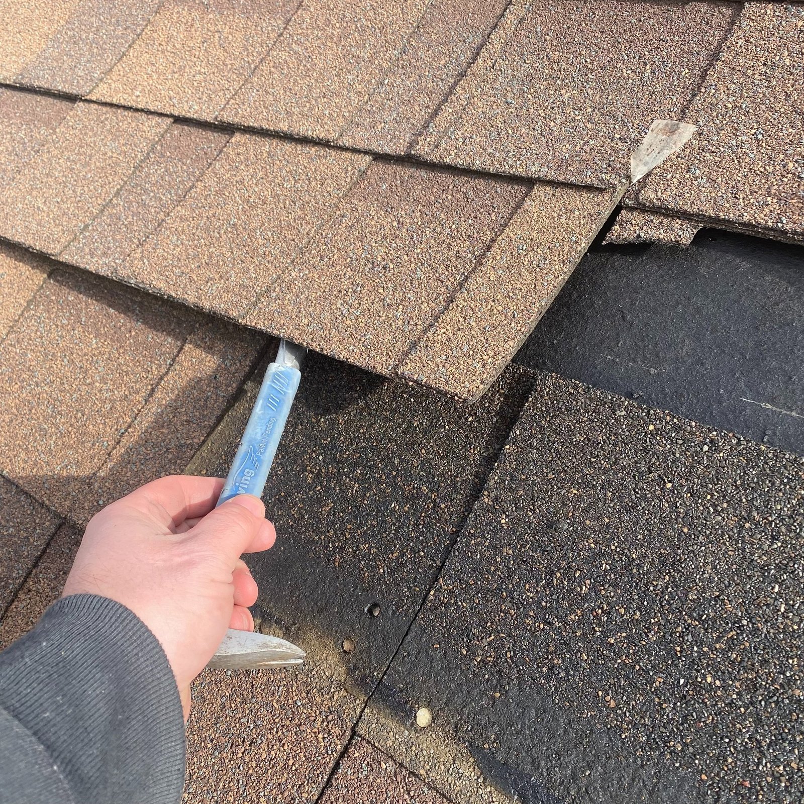 Missing shingle on a roof in the Appleton area, before repair