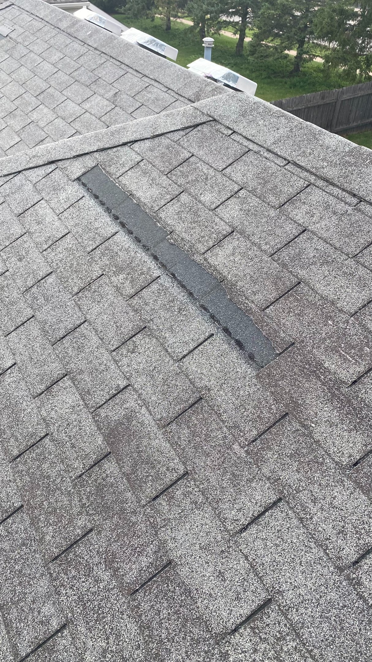 Shingle missing with granular loss on a Wisconsin roof