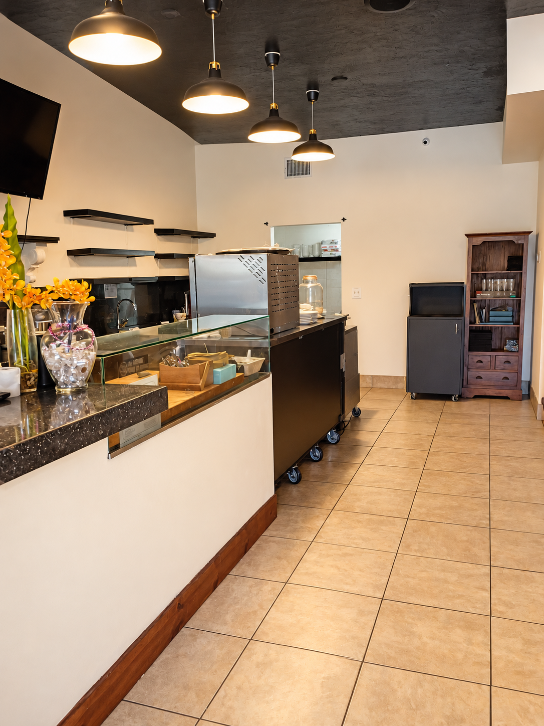 Service counter, pendant lights and tile floor inside TARNA