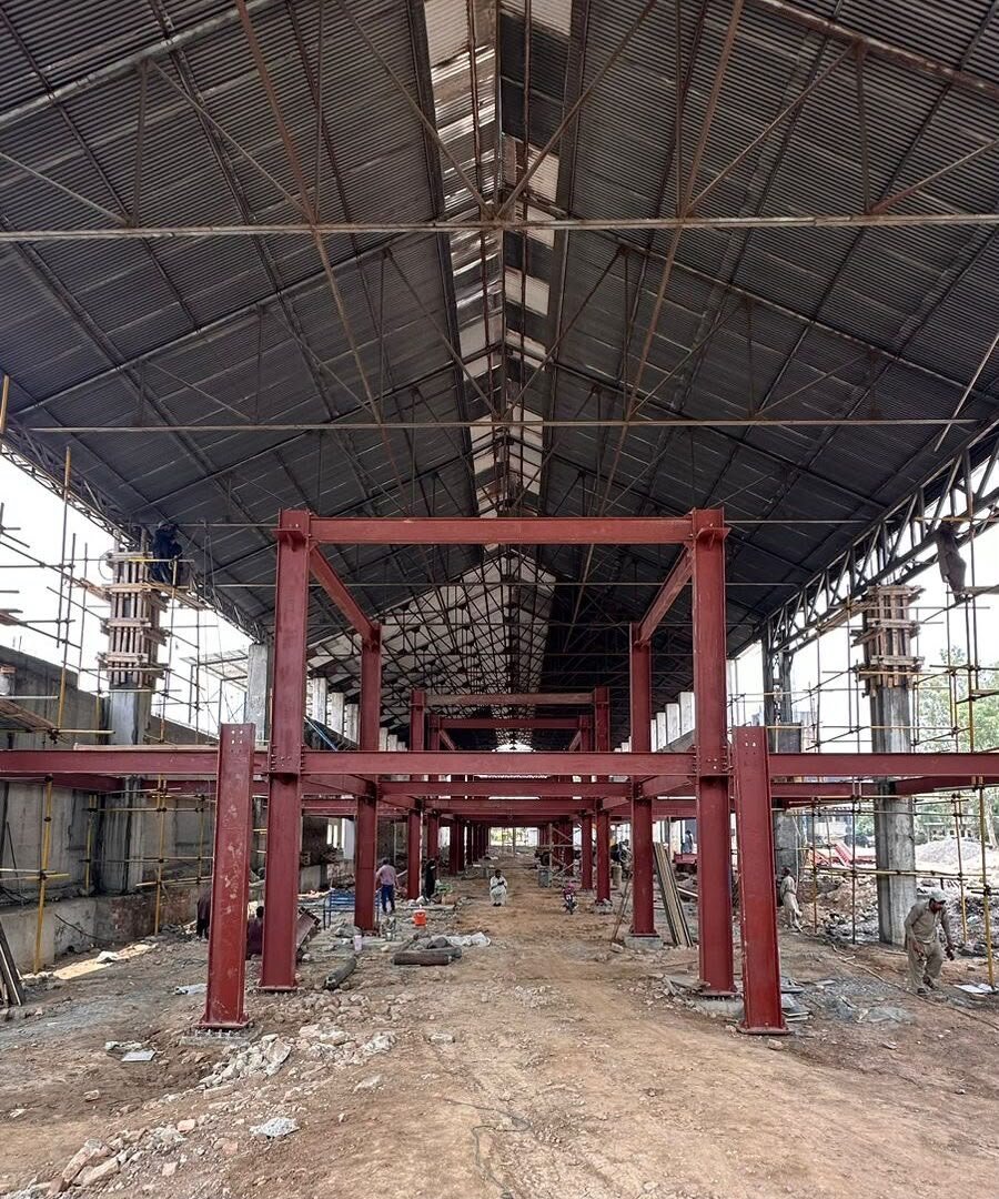 Red steel mezzanine beams and roof structure during construction
