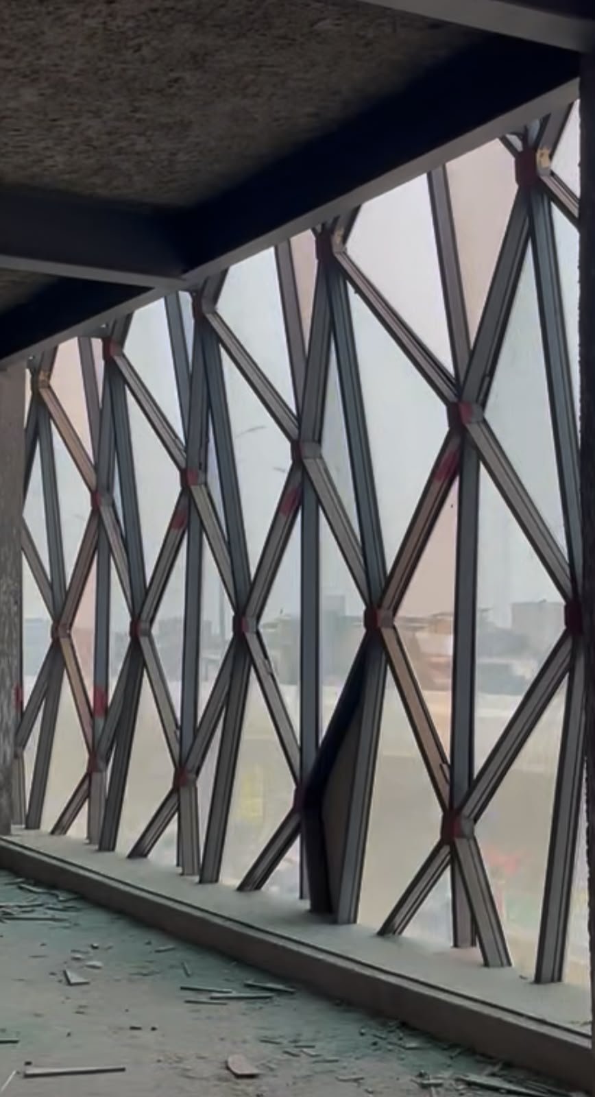 Interior view of the Ali Center steel diagrid lattice behind the glass panels