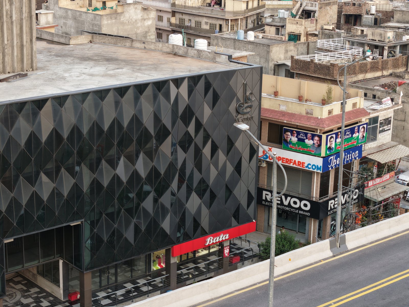 Street-level view of Ali Center diagrid facade with Bata storefront