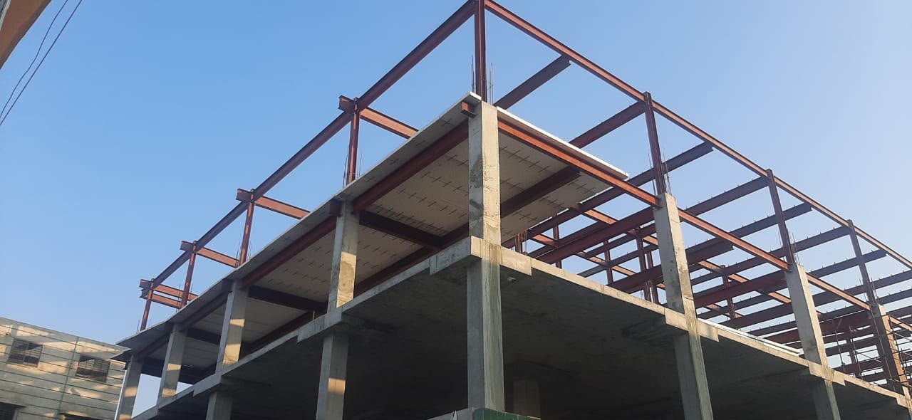 Ali Centre multi-story steel frame under construction against clear sky