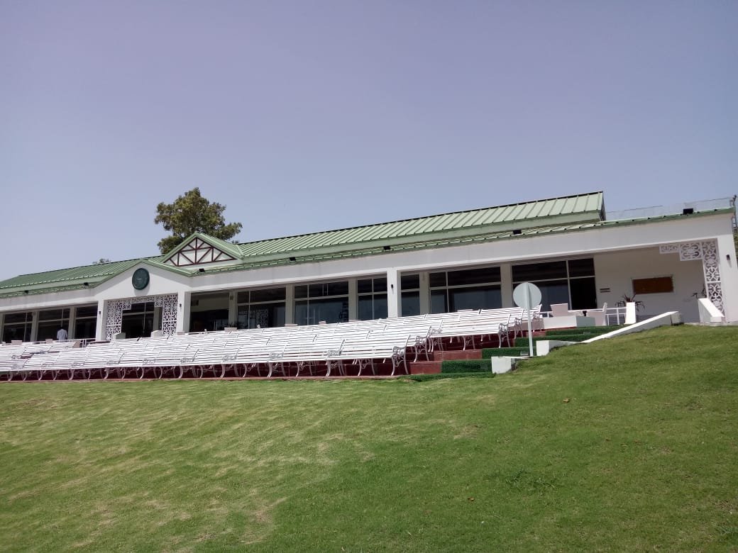 Cricket pavilion exterior with covered seating and lawn