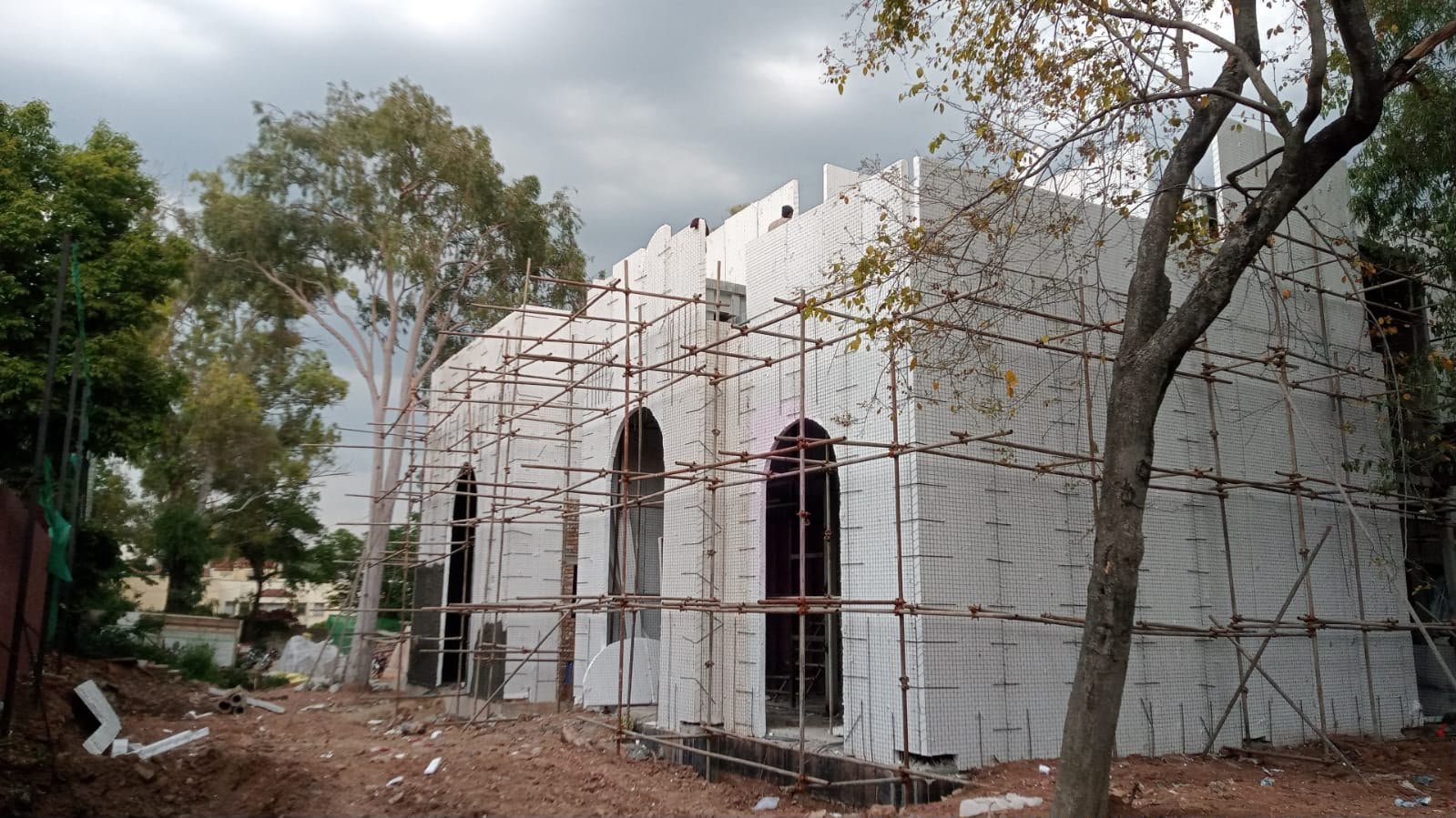 SCIP panel residence under construction with scaffolding and arched openings in Sector G-6, Islamabad