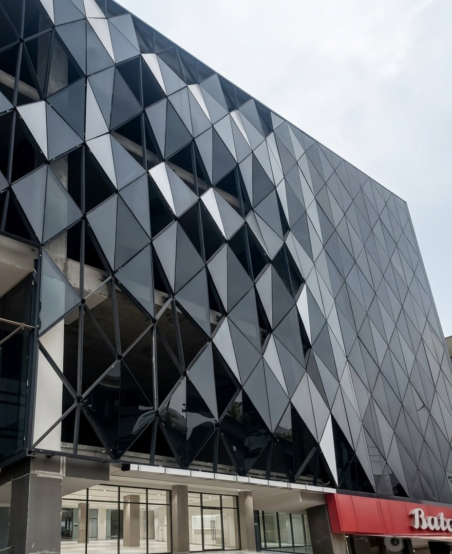Low-angle view of Ali Center dark diamond-grid diagrid glass facade