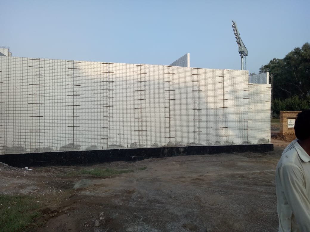 Wire-mesh reinforced wall panels during pavilion construction