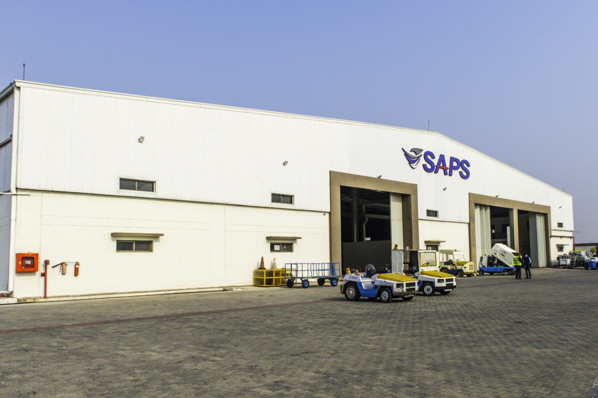 SAPS hangar exterior with ground equipment on the apron