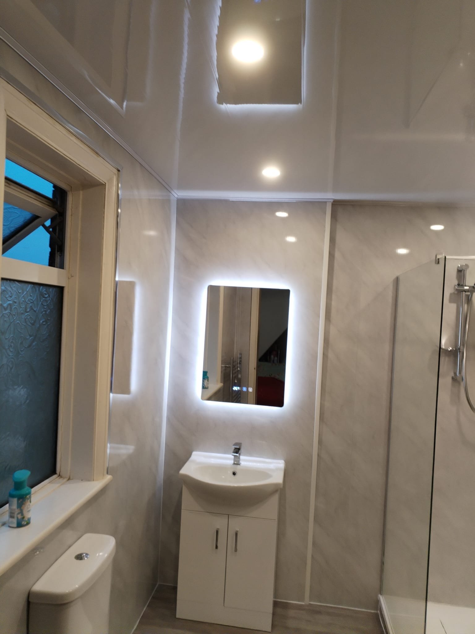 Bathroom renovation work in progress with exposed pipes and construction elements