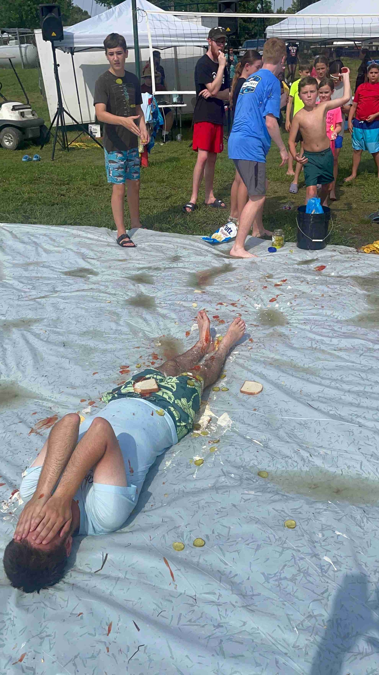 Human sandwich game on slip and slide