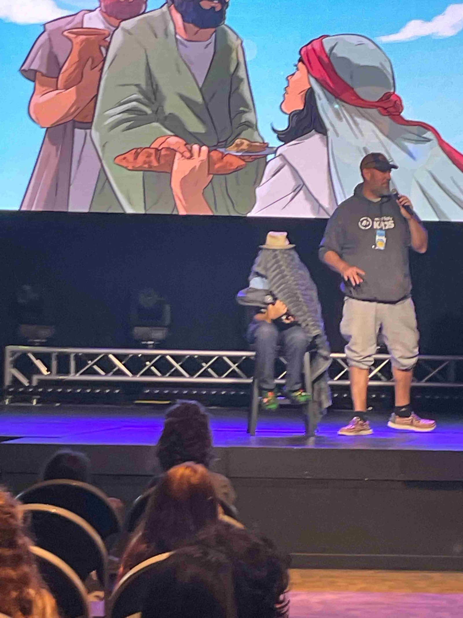 Youth leader speaking on stage during skit
