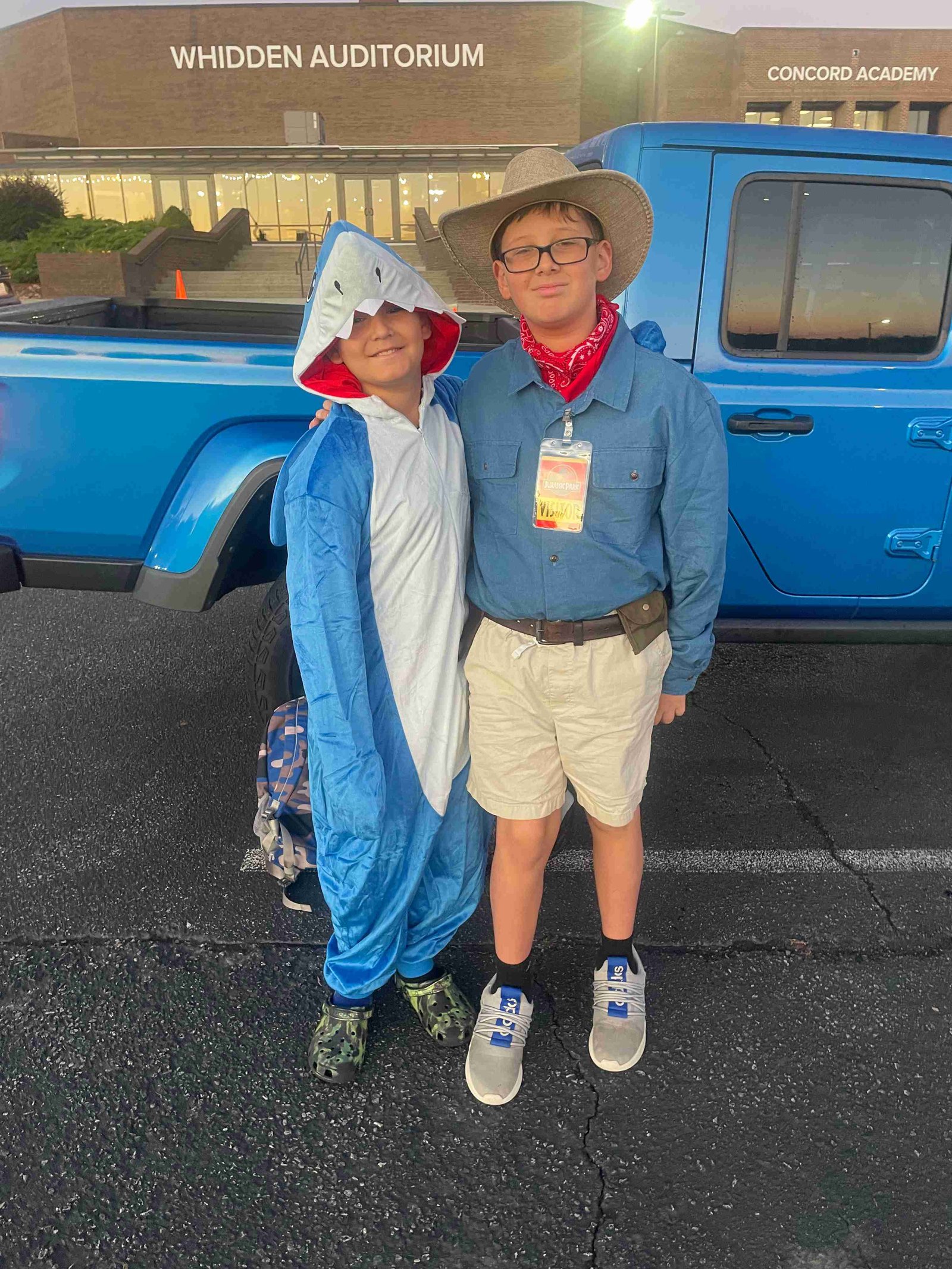 Boys in costumes, one as a shark and one as a safari guide