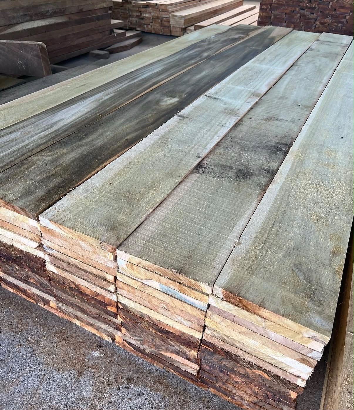 Stacked sawn teak boards in a timber yard