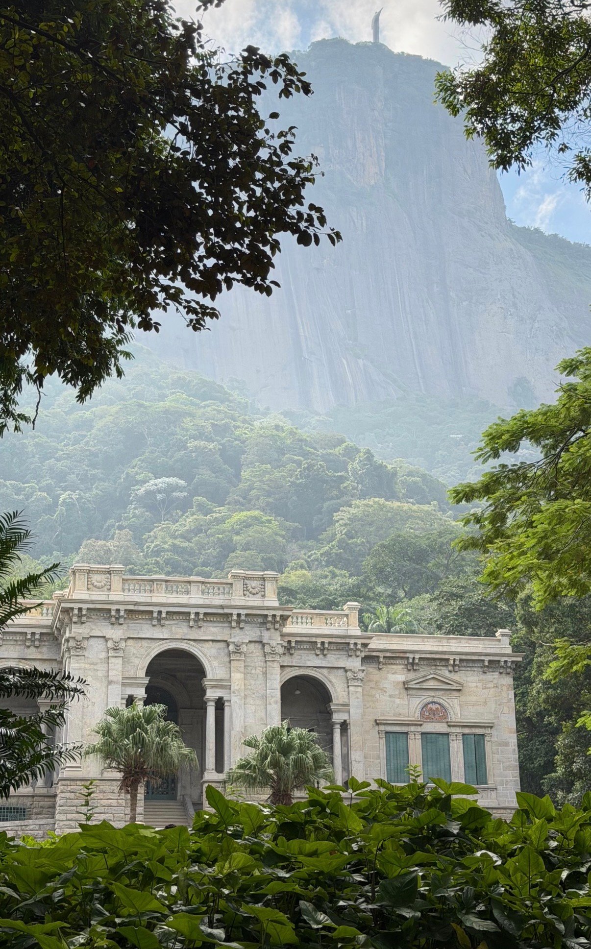 Monumental statue over city and forest