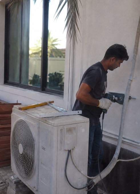 Professional AC technician installing outdoor AC unit