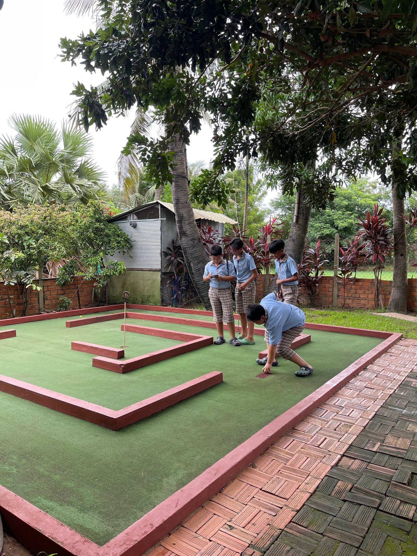 School group enjoying mini golf