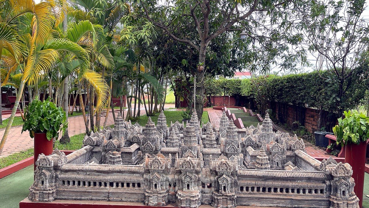 Full view of elaborate temple replica model in garden