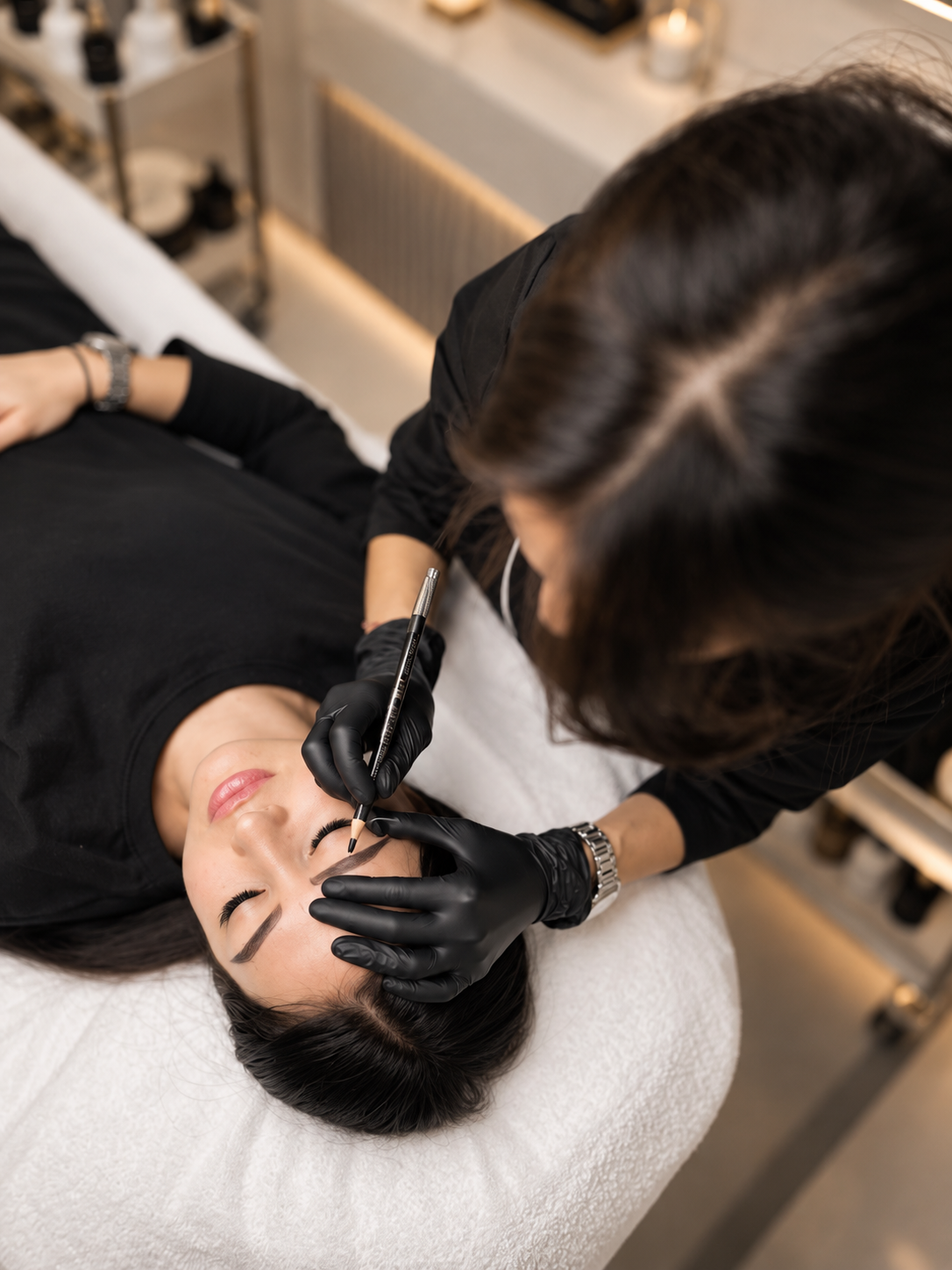 Brow mapping with pencil during a professional brow design session