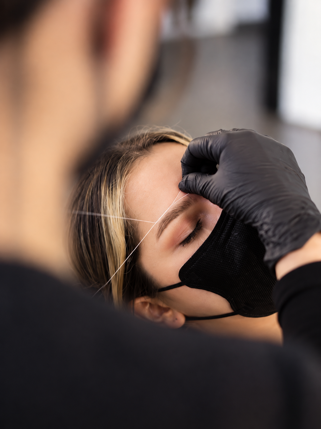 Precise brow threading for clean natural arches