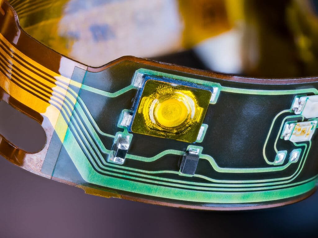 Selective soldering machine soldering through-hole component pins on a printed circuit board