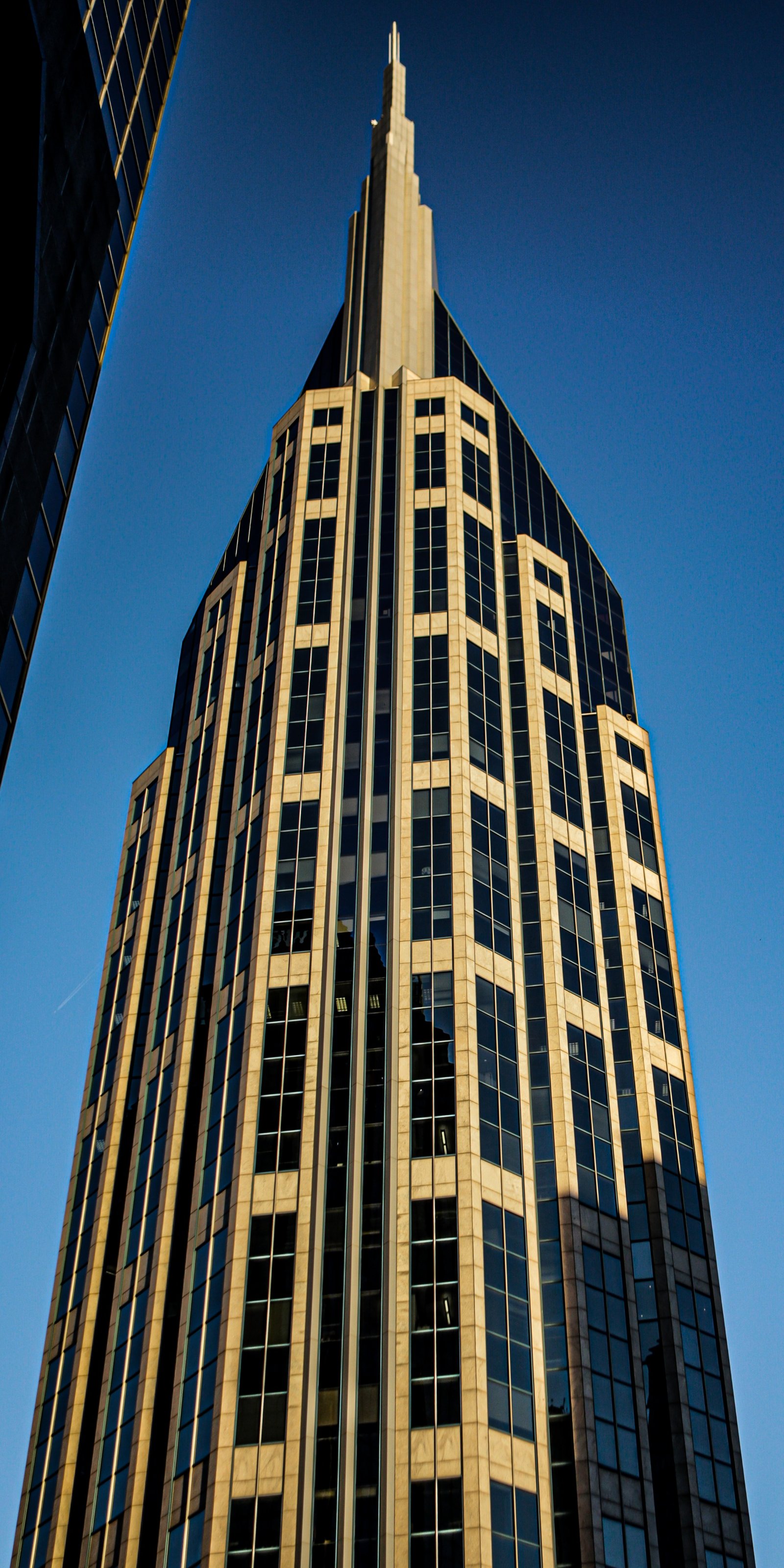 Geometric facade of a modern apartment building with repeating balconies in late sun