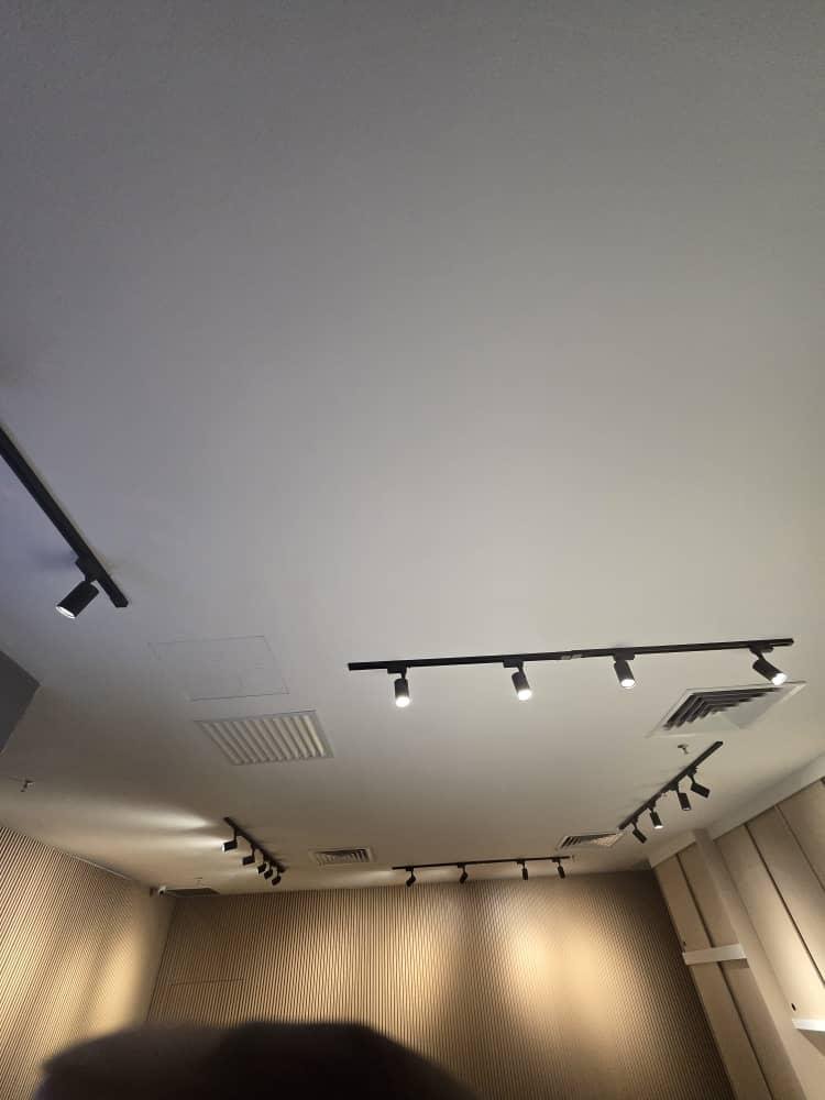 Completed ceiling with black track lights over timber wall panelling at KLEM Clinics retail area
