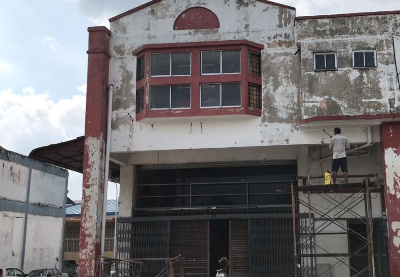 Before: Weathered building exterior before Tresman Painting facade works