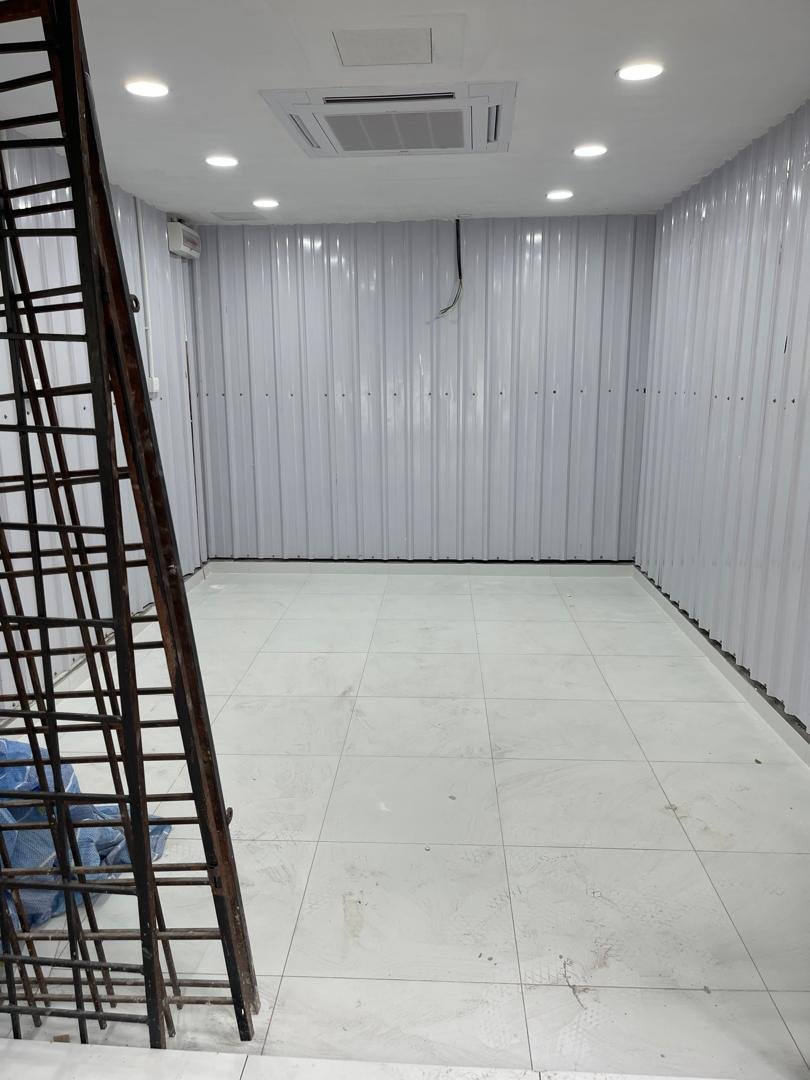 Completed bright white commercial interior at Emart Brickfield with corrugated wall panels and cassette AC