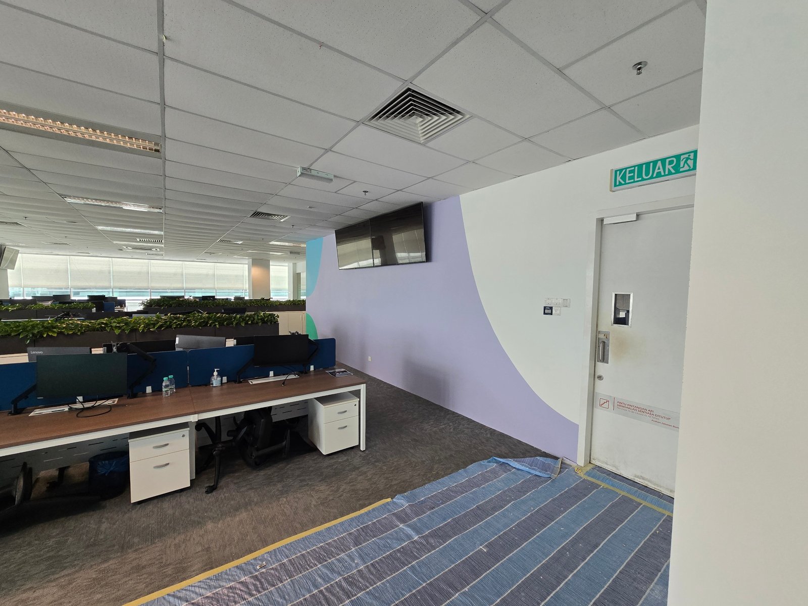 Office corridor at Nasstar Cyberjaya with lilac and purple feature wall curve and exit door