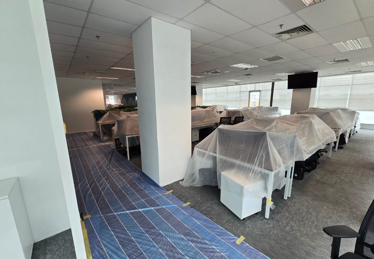 Before: Office desks protected during commercial painting