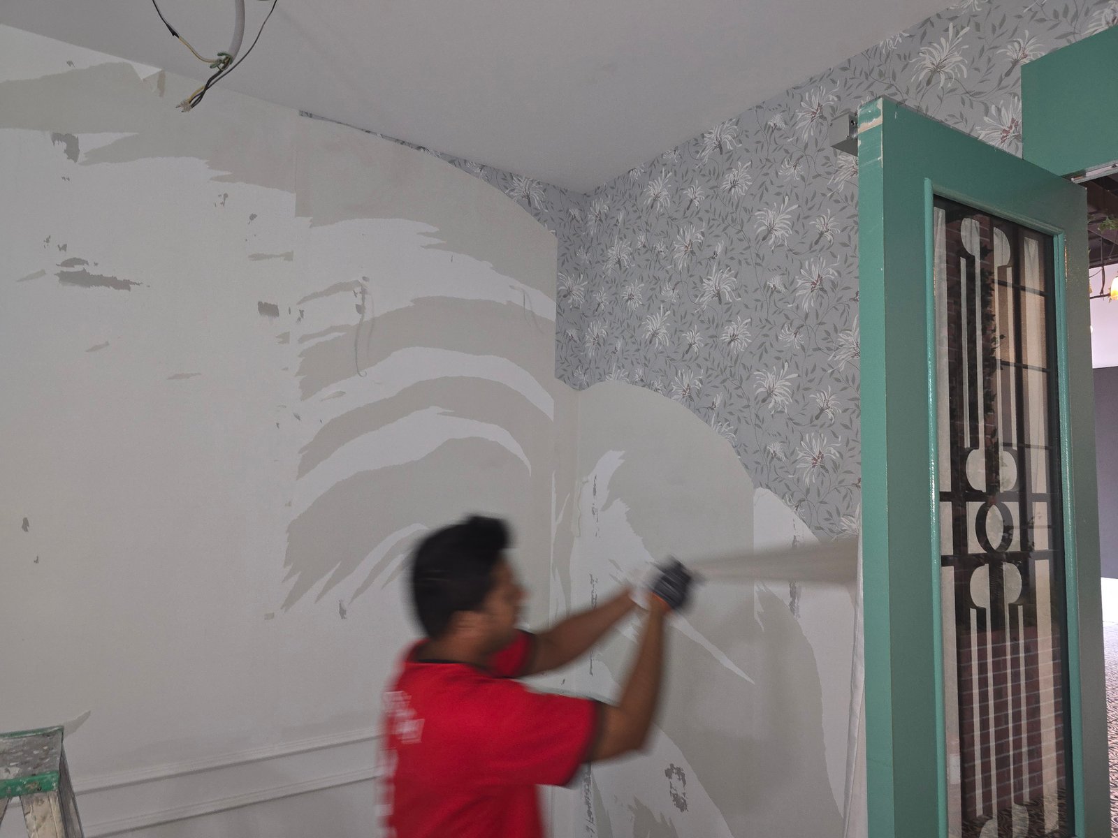 Wall plastering and surface preparation alongside decorative wallpaper at GD Properties KLCC