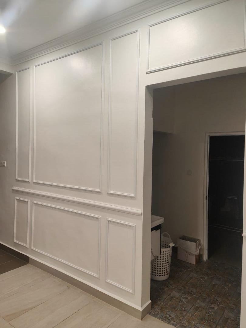 Elegant white French wainscoting wall panels at KLEM Clinics with precision-painted finish