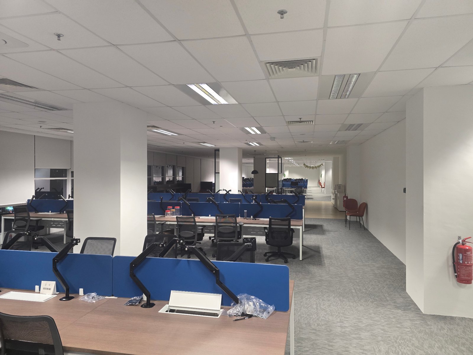Large completed open-plan office at Nasstar Cyberjaya with blue dividers and bright overhead lighting