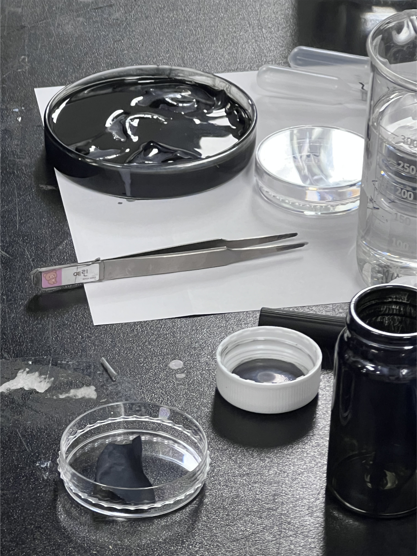 Laboratory bench at Hanyang University with research materials including petri dishes, glassware, and analytical instruments