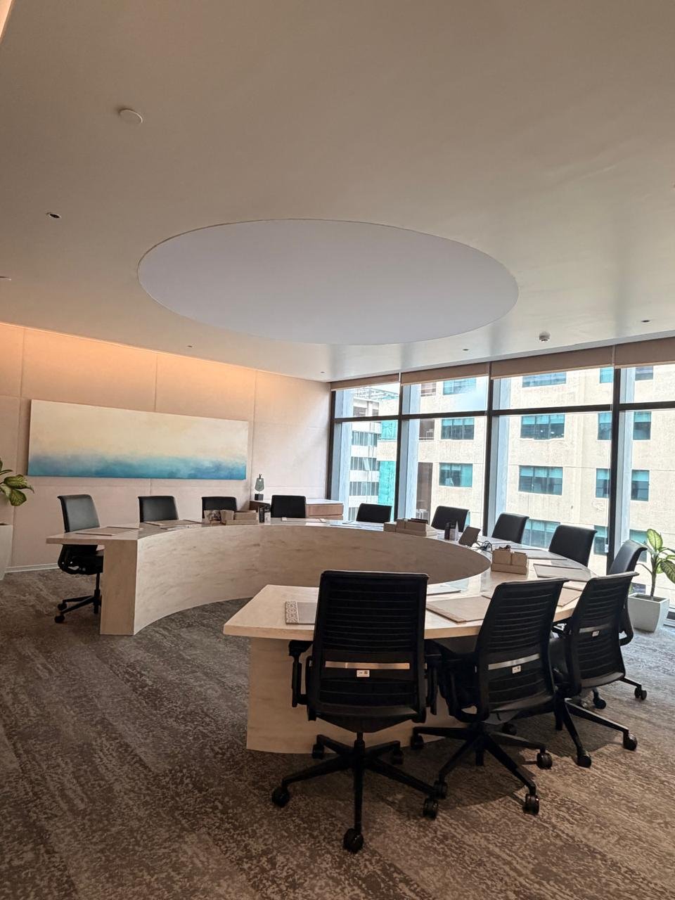 Executive boardroom with curved marble desk and city views at BIA