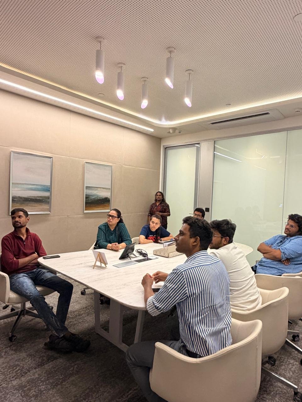 BIA learners seated around a conference table in a modern classroom
