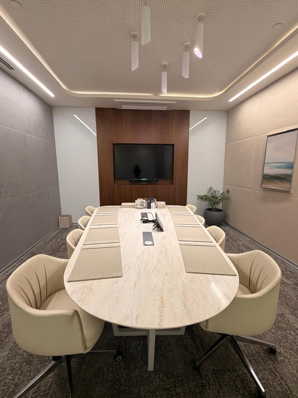 Empty BIA training room with marble table and wall-mounted display