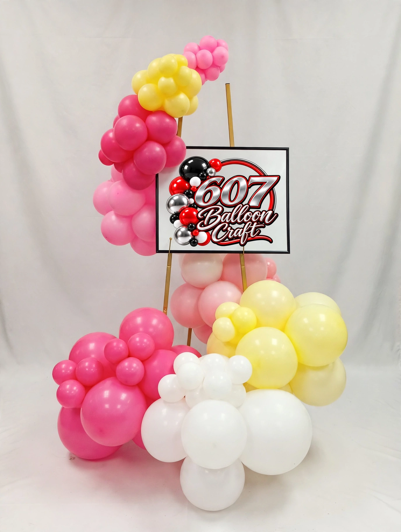 Easel with wrap-around organic balloon garland by 607 Balloon Craft